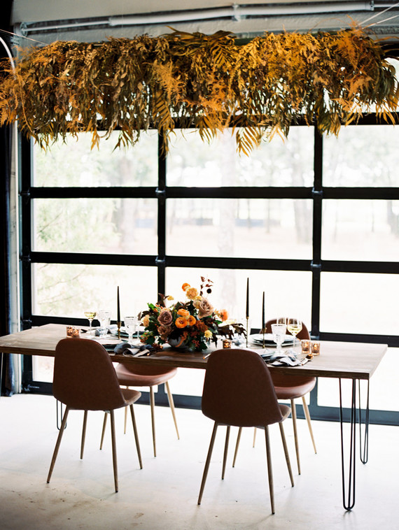 Minimal and modern chairs and furniture embellished by warm fall florals decorated the modern fall wedding theme