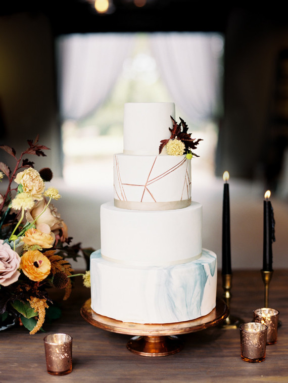 A beautifully elegant and modern fall wedding cake adorned with ribbon and trendy marble