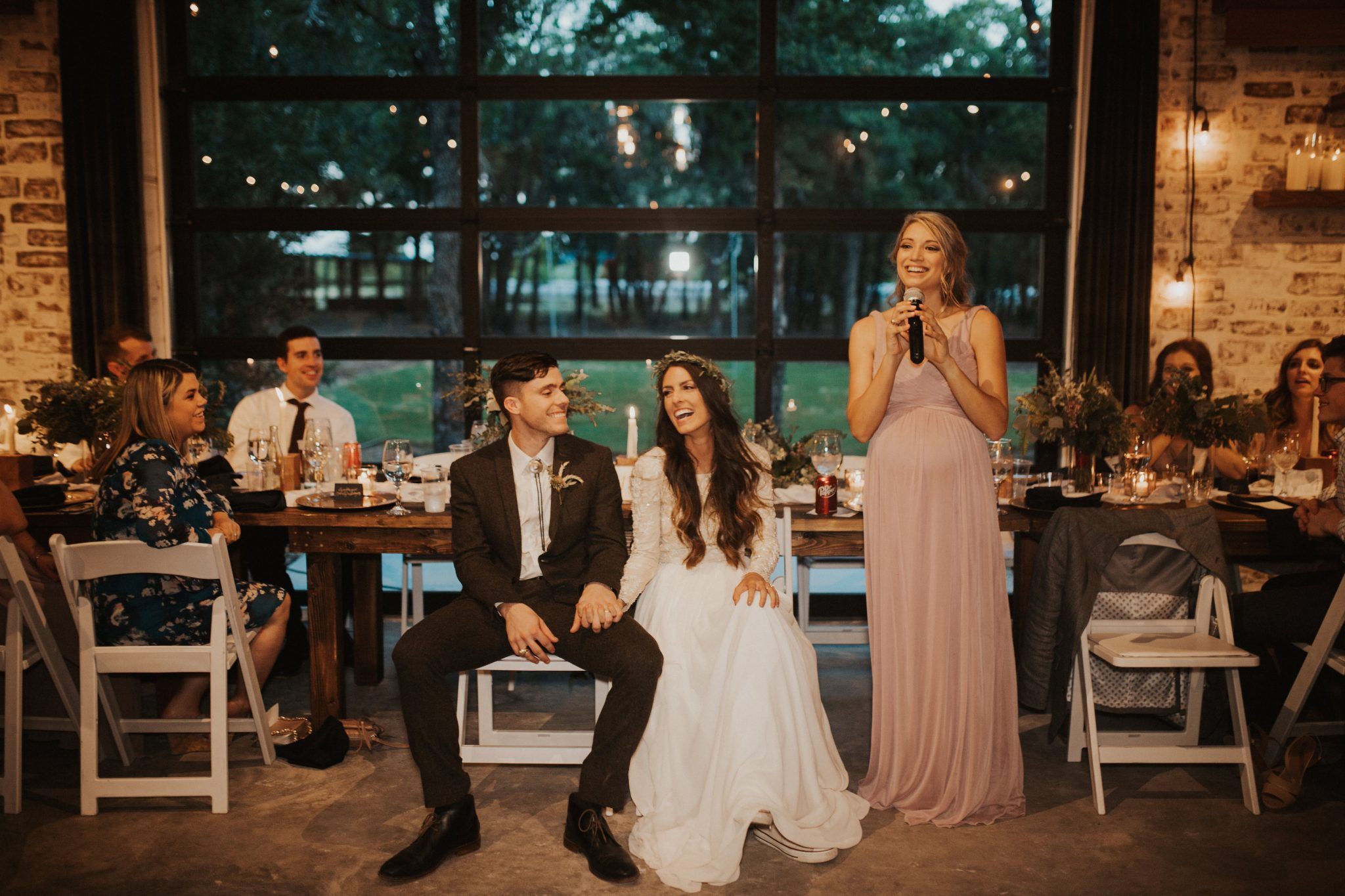 A bridesmaid gives a speech at the indoor barn wedding reception