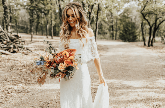Boho Chic Fall Wedding bride Hannah poses in the open natural grounds of the wedding venue space.